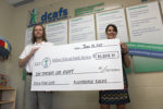 Kushindokai Karate and Fitness owner and head instructor Michael Fisher presents a cheque for $10,008.75 to Dufferin Child and Family Services Executive Director Jennifer Moore.