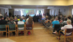 Students, parents, Lord Dufferin Centre staff, and residences celebrating the unveiling of Island Lake Public School’s Grandpals Gala. The project saw the school’s grade four and five students interacting with residences of the centre, learning not only about their lives, but life in general, from the Great Depression and the Second World War. The project is designed to get kids active in the community and bridge generational gaps.