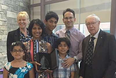 HEADWATERS’ GOVERNANCE Committee Chair Lori Kerr (back left) and Dr. David Scott (far right) present Drs. Stephen and Stephanie Milone, and their children, with the 2017 Dr. David Scott Award in a special ceremony at Headwaters Health Care Centre’s AGM, Monday.