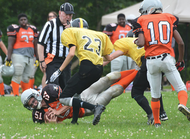 Orangeville Outlaws Junior Varsity player, Jordan Payne, dives across the goal line during the fourth quarter of Sunday’s (July 23) game against the TNT Express at Westside Secondary School in Orangeville. Payne scored the only Orangeville TD of the game. The Outlaws season is now over. This game ended with a 38-6 loss for the Outlaws.