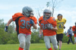 Orangeville’s Lucas Snowdon runs blocking for ball carrier Jack Roud during Sunday’s (July 9) Bantam game against the TNT Express at Westside Secondary School. The Outlaws got off to a good start with two early touchdowns and finished the game with a 40-6 win.